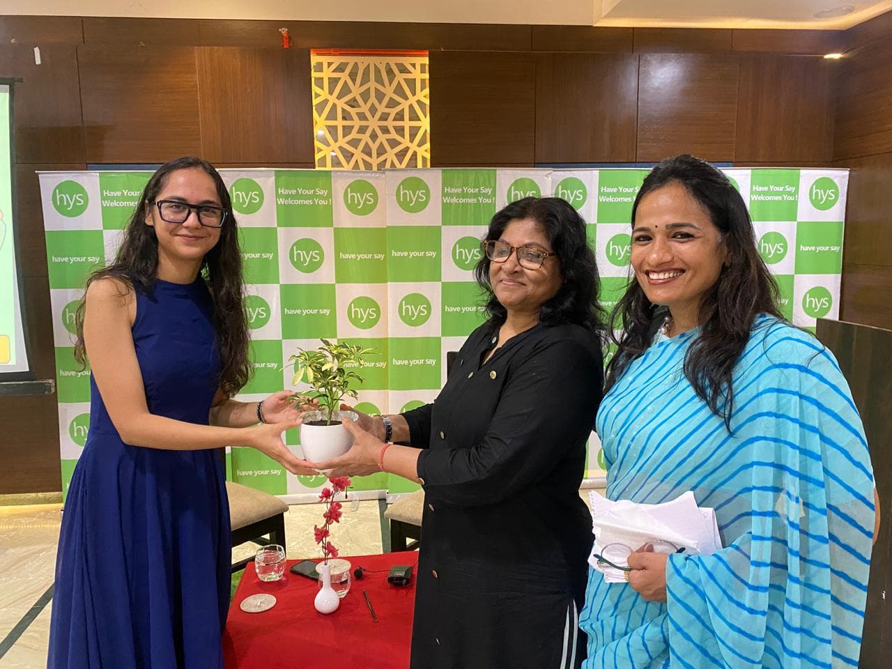 Monali receiving a plant at a Have Your Say event
