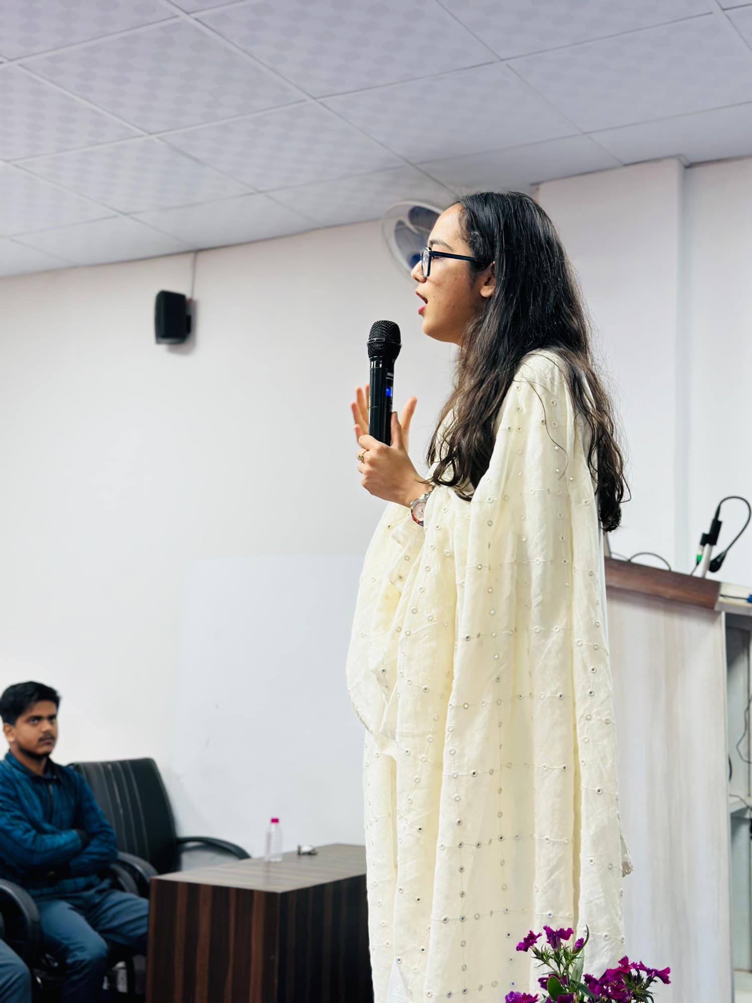 Monali speaking on stage